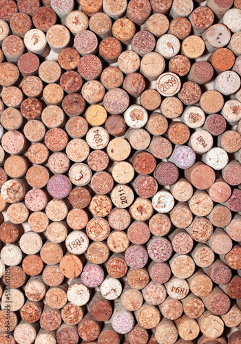 Abstract background of used red wine corks and white wine corks with corkscrew marks on corks and calendar dates on some corks