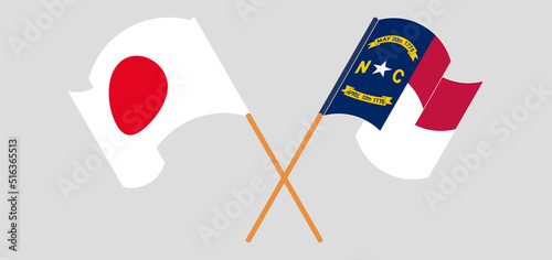 Crossed and waving flags of Japan and The State of North Carolina