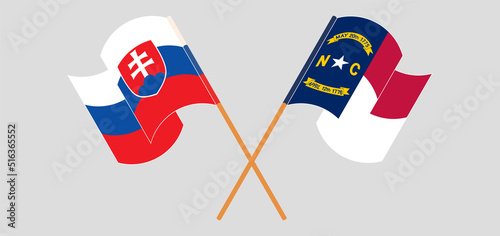 Crossed and waving flags of Slovakia and The State of North Carolina