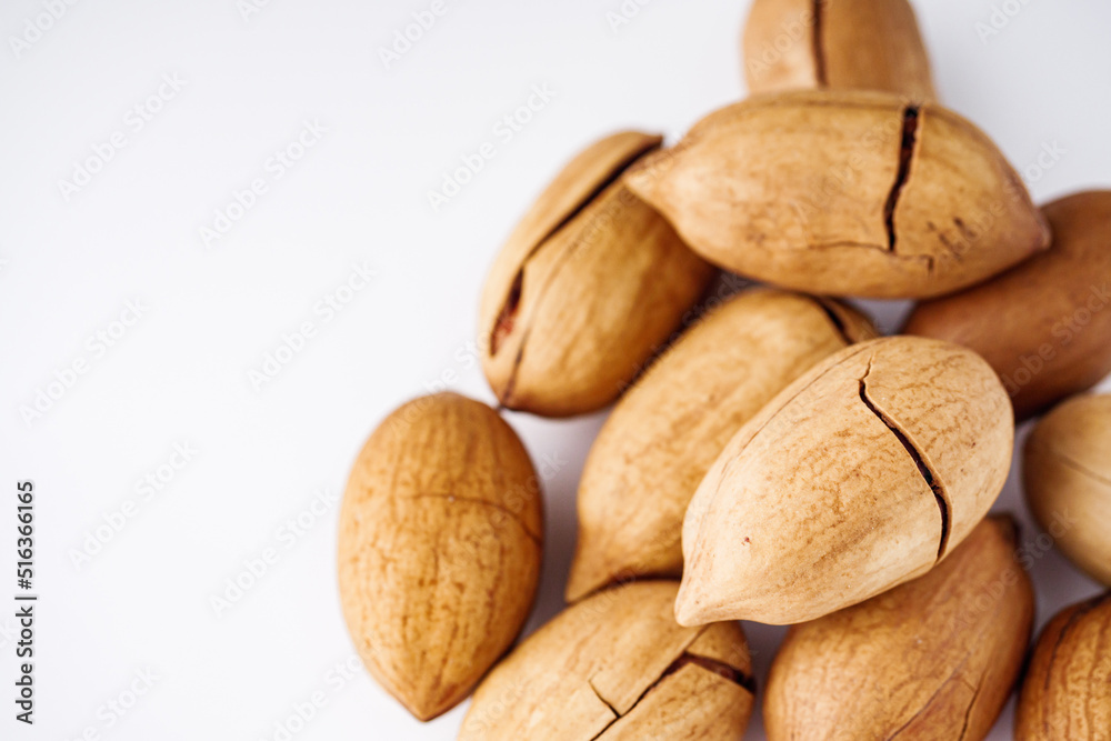 delicious fresh pecans on a white acrylic background delicious fresh pecans on a white acrylic background