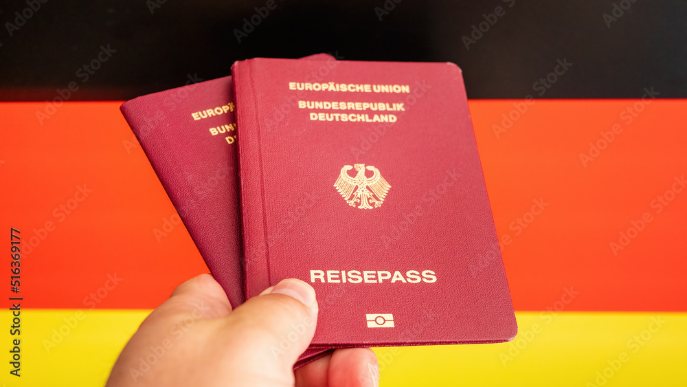 Two German passport in male hand on check in. Concept Idea Two German passport in male hand on check in. Concept Idea