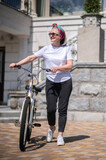 Good-looking woman with a bike looking enjoyed and excited
