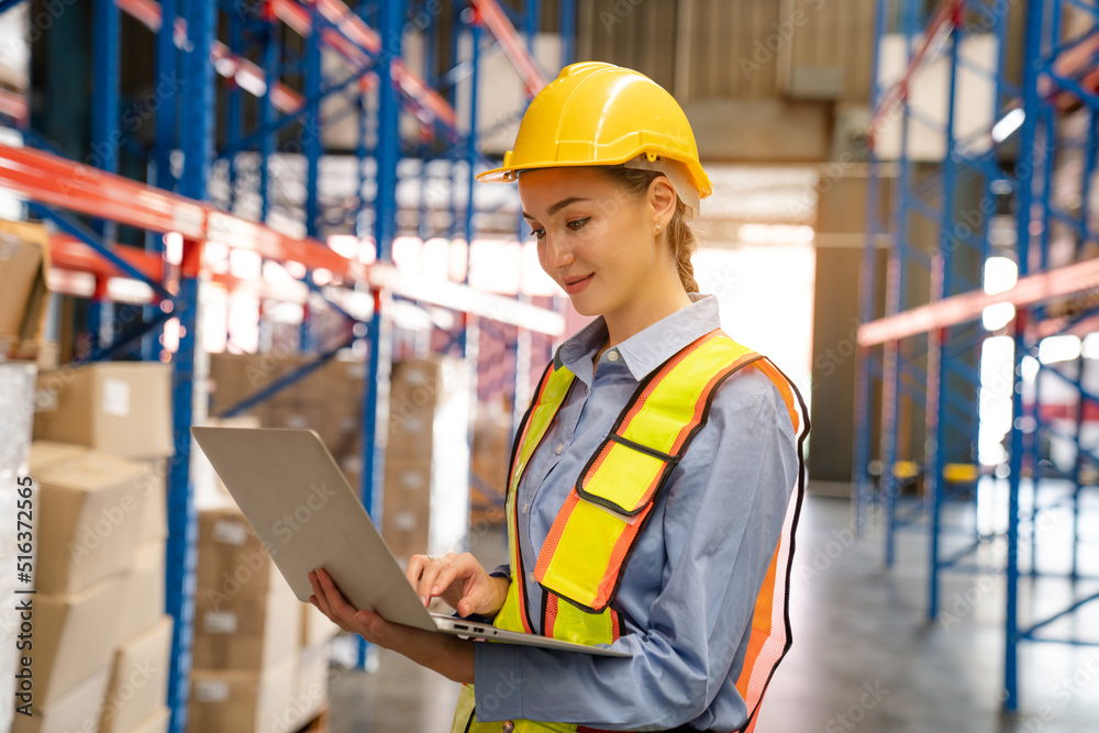 Portrait of female worker using laptop working in warehouse, Industrial and industrial workers concept. Portrait of female worker using laptop working in warehouse, Industrial and industrial workers concept.