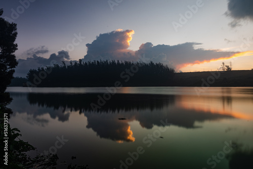 Serene view of a lake during sundown captured using long exposure with perfect reflection