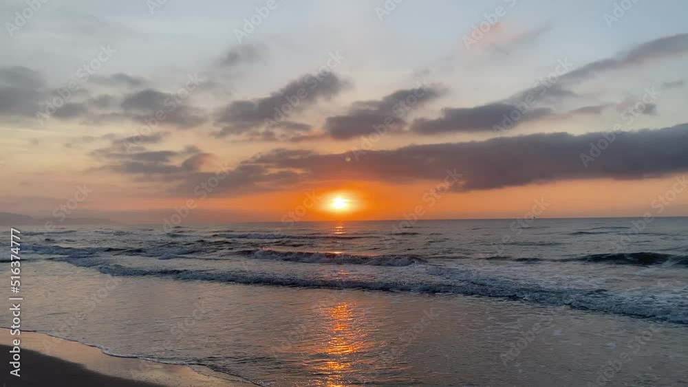 Dramatic sea sunrise or sunset. Burning cloudy sky and shining golden waves. High quality 4k footage Dramatic sea sunrise or sunset. Burning cloudy sky and shining golden waves. High quality 4k footage