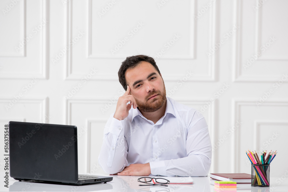 ADHD with computer young brunette office worker at work behind the desk trying to think