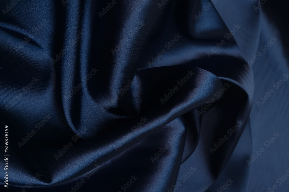 Blue crumpled or wavy fabric texture background. Abstract linen cloth soft waves. Silk atlas or stretch jacquard. Smooth elegant luxury cloth texture. Concept for banner or advertisement.