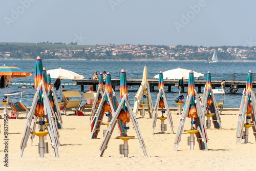 Vászonkép Deck chairs and parasols on a sandy beach in Portoroz, Slovenia.