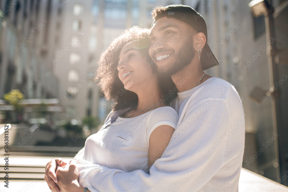 Lovely young couple in sunlight looking happy Lovely young couple in sunlight looking happy