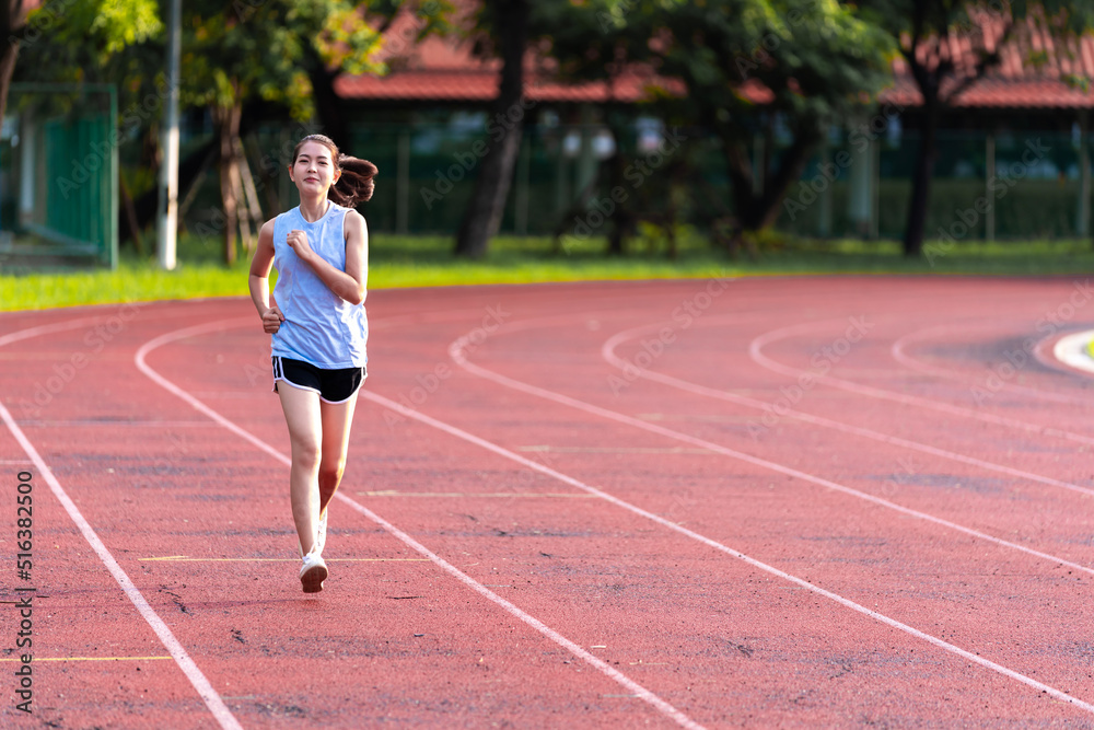 Asian women are jogging in the morning at the stadium to keep fit and healthy.