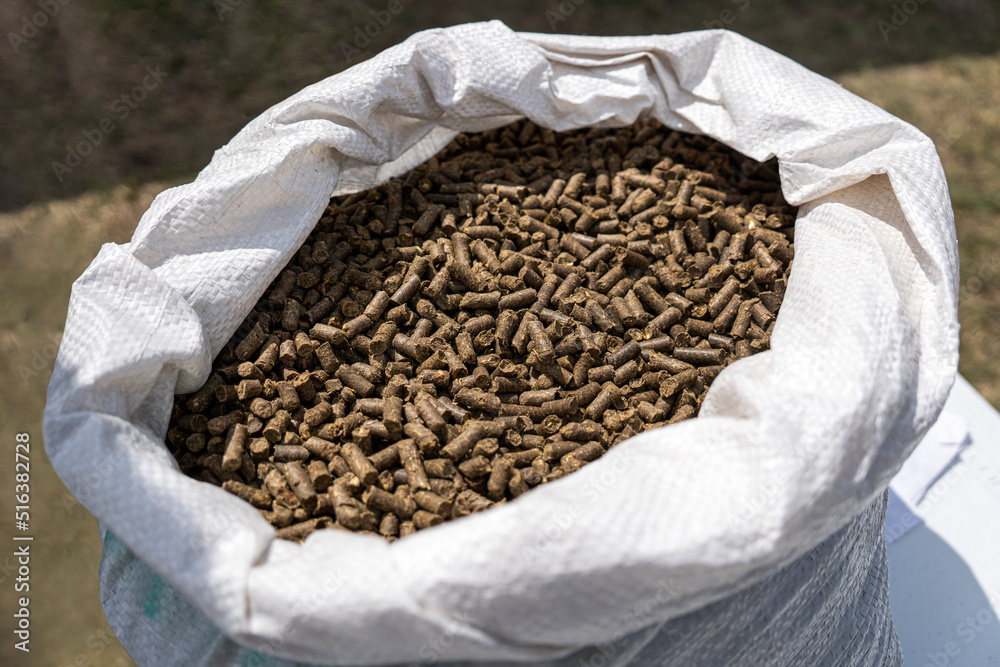 processing of bird droppings into fertilizer. Closeup view of paper bag with fertilizer on