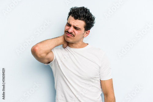 Young caucasian man isolated on blue background having a neck pain due to stress, massaging and touching it with hand.