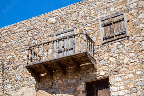 Wooden balcony on an old stone house