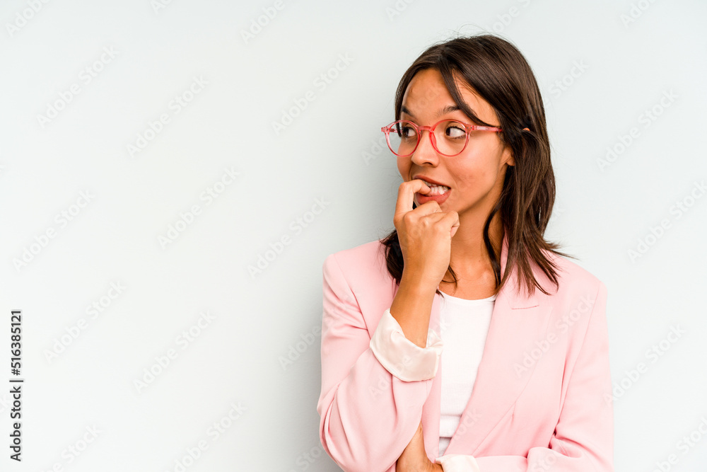 Young hispanic woman isolated on blue background praying for luck, amazed and opening mouth looking to front. Young hispanic woman isolated on blue background praying for luck, amazed and opening mouth looking to front.