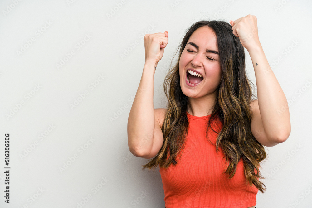 Young caucasian woman isolated on white background raising fist after a victory, winner concept. Young caucasian woman isolated on white background raising fist after a victory, winner concept.