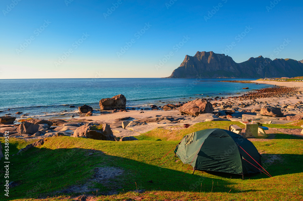 Camping at sunset with a tent on Uttakleiv beach in Lofoten islands, Norway