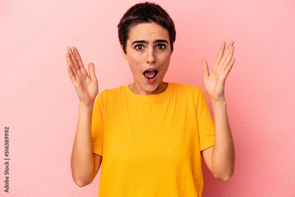 Fototapeta premium Young caucasian woman isolated on blue background celebrating a victory or success, he is surprised and shocked.