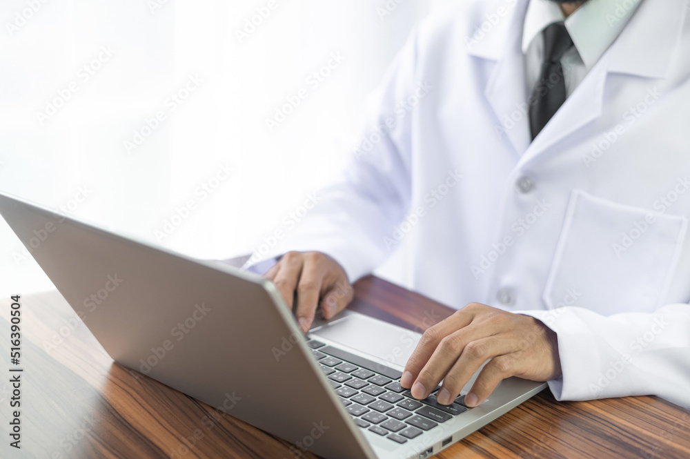 Doctor working with computer notebook in hospital office, Healthy medical concept Doctor working with computer notebook in hospital office, Healthy medical concept