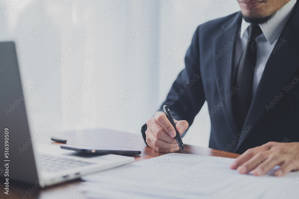 Businessman working in office and hand writing on document financial business management for business planning 2022 to 2023