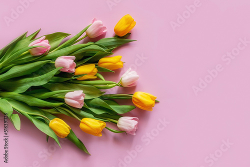 card from a bouquet of tulips on a pink background with a place for text