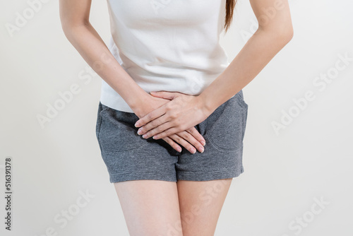 woman having painful lower stomach and hands holding pressing her crotch lower abdomen