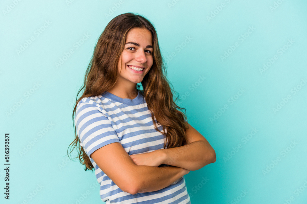 Young caucasian woman isolated on blue background  happy, smiling and cheerful.