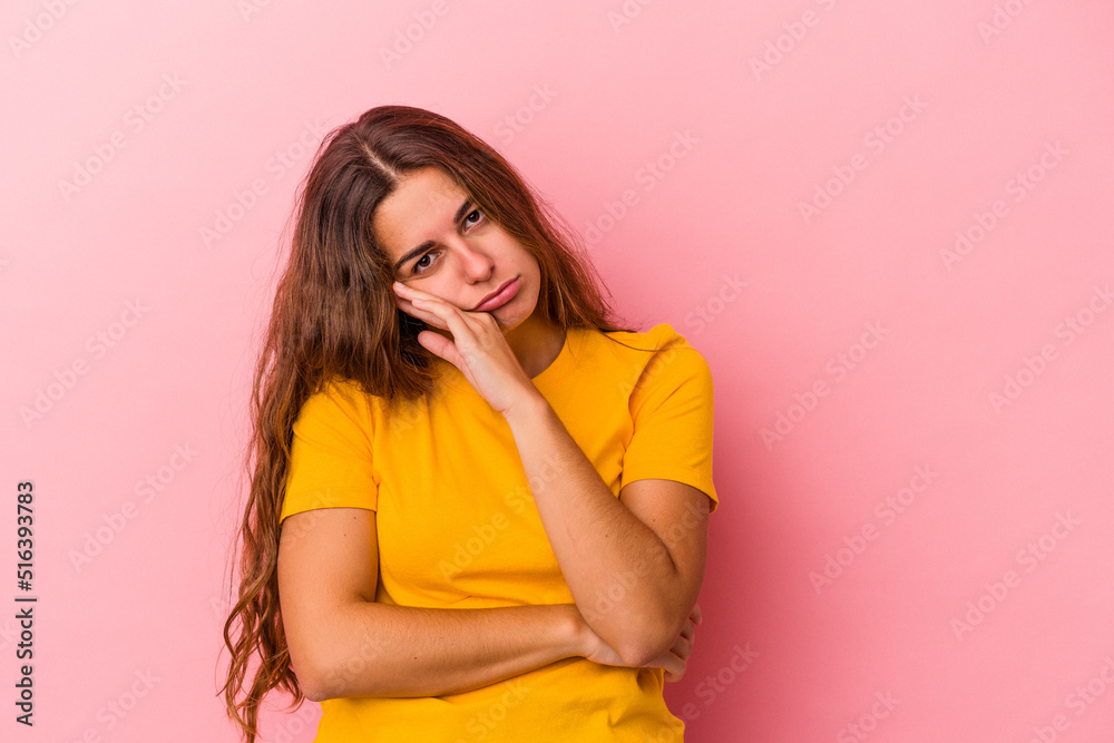 Young caucasian woman isolated on pink background tired of a repetitive task. Young caucasian woman isolated on pink background tired of a repetitive task.