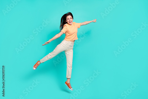 Fototapeta Naklejka Na Ścianę i Meble -  Full size photo of ecstatic gorgeous girl jumping raise arms flying isolated on turquoise color background