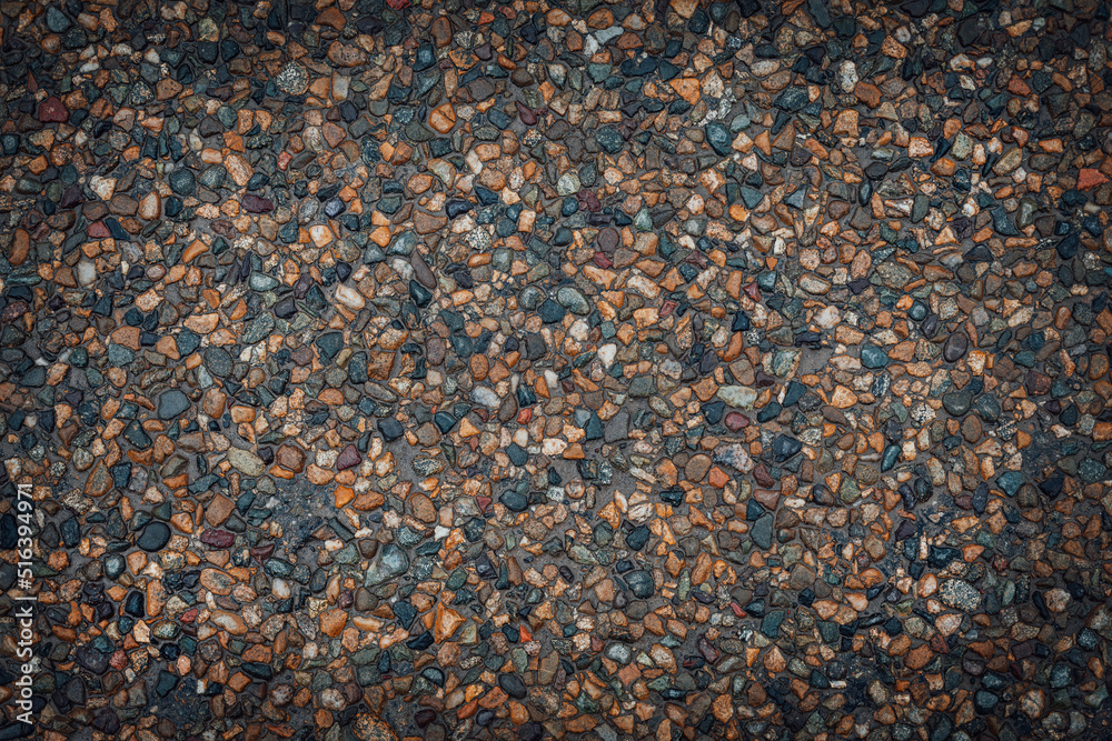 Texture of small multi-colored stones. Asphalt background. Texture of small multi-colored stones. Asphalt background.