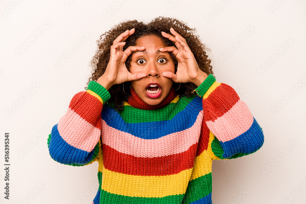 Young African American woman isolated on white background keeping eyes opened to find a success opportunity. Young African American woman isolated on white background keeping eyes opened to find a success opportunity.