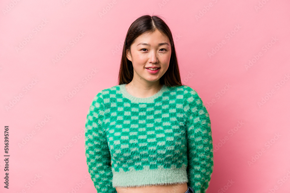 Young Chinese woman isolated on pink background happy, smiling and cheerful. Young Chinese woman isolated on pink background happy, smiling and cheerful.