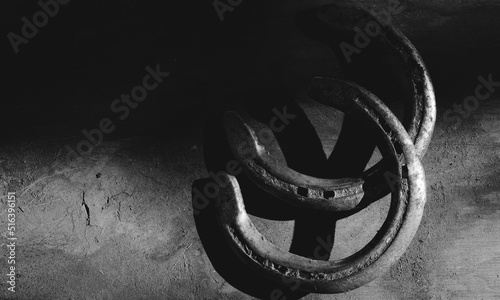 Horseshoes on black and white background for equine horse western industry concept.