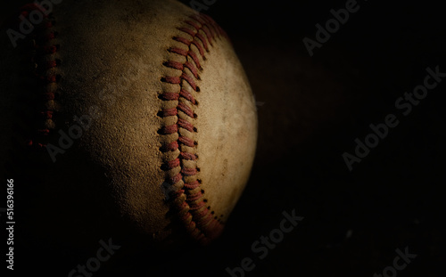 Canvas Print Old used baseball ball closeup, isolated on dark black background with copy space