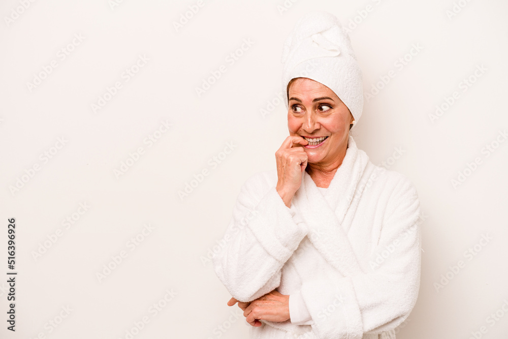 Middle age caucasian woman wearing a bathrobe isolated on white background relaxed thinking about something looking at a copy space. Middle age caucasian woman wearing a bathrobe isolated on white background relaxed thinking about something looking at a copy space.