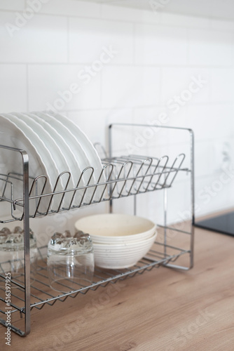 White clean dishware in drainer after washing photo