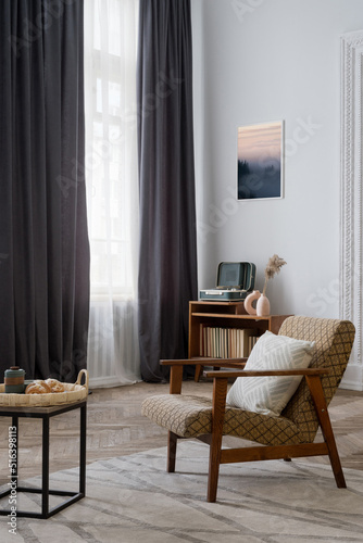 Comfort armchair in living room at retro style apartment