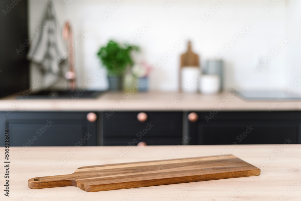 Wooden cutting board on tabletop in kitchen