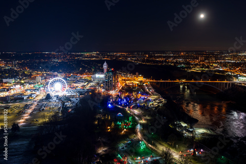 Niagara Falls City, Ontario, Canada - December 19 2021 : Overlooking the Niagara River Rainbow Bridge night view.