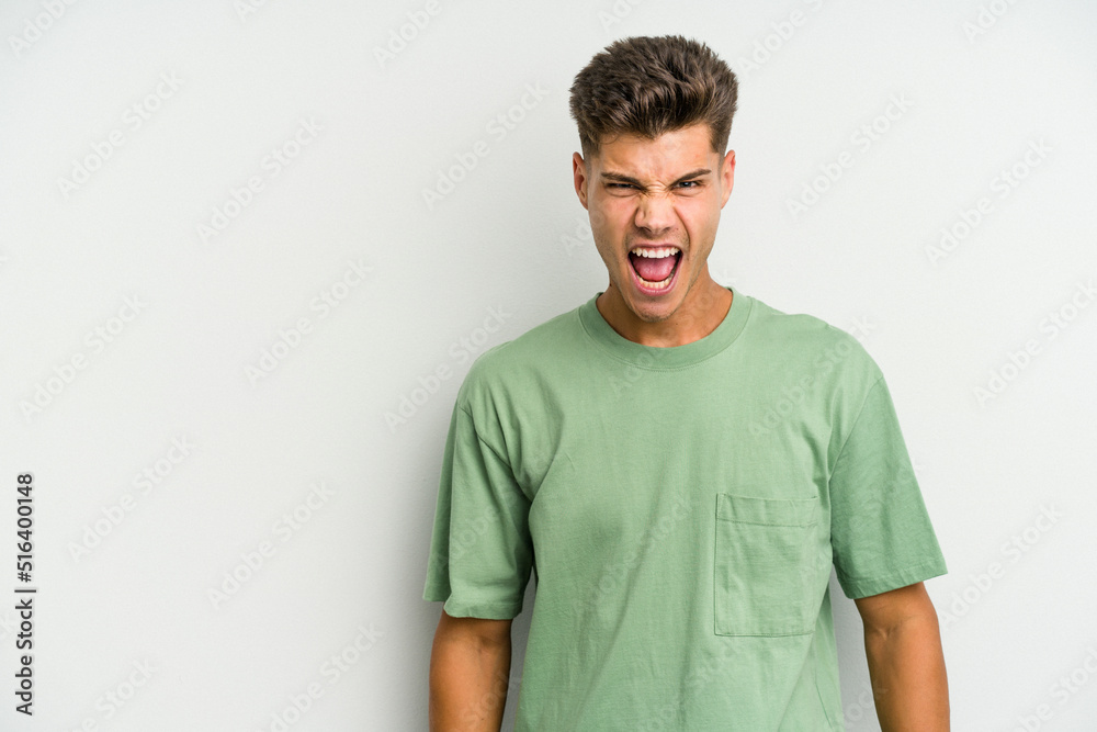 Young caucasian man isolated on white background shouting very angry, rage concept, frustrated. Young caucasian man isolated on white background shouting very angry, rage concept, frustrated.
