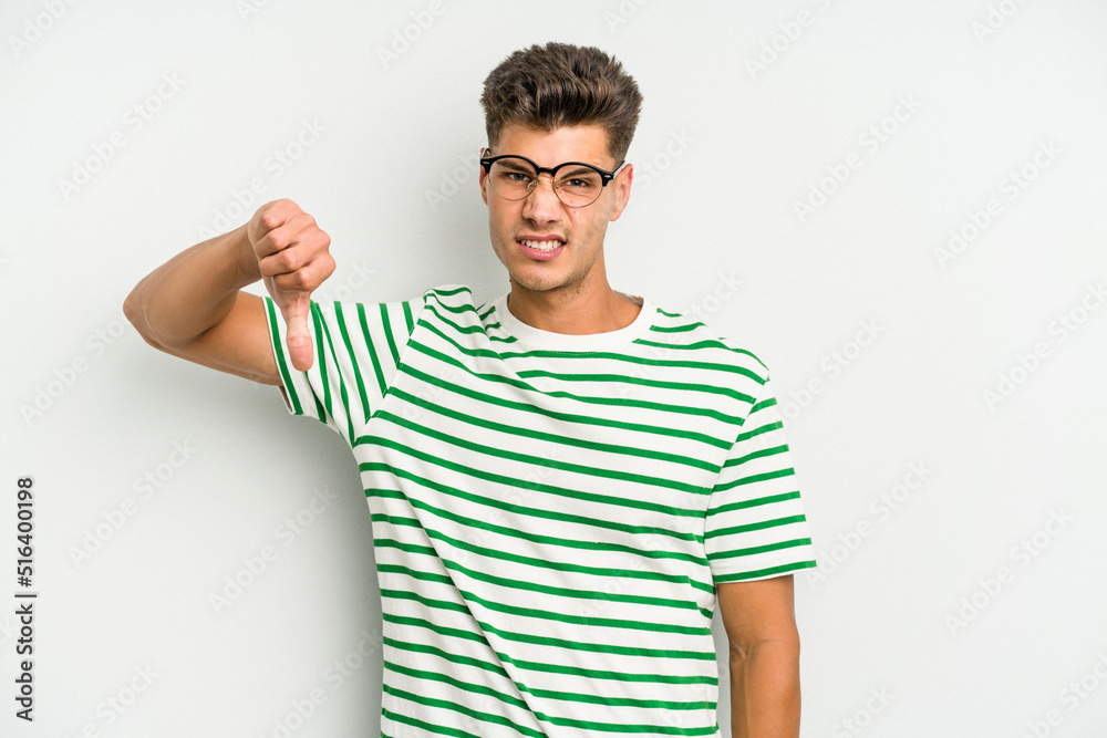 Fototapeta premium Young caucasian man isolated on white background showing thumb down, disappointment concept.