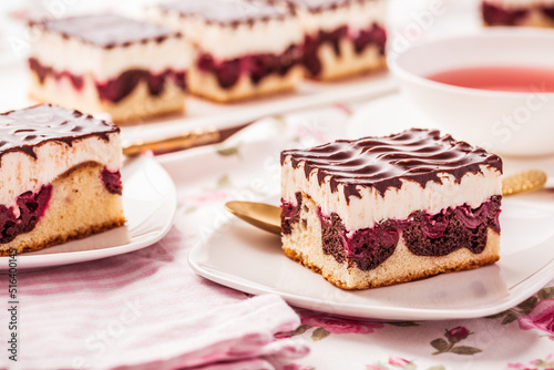 German cake Donauwelle (Danube waves) - vanilla and chocolate sponge cake with sour cherries, vanilla buttercream and chocolate icing