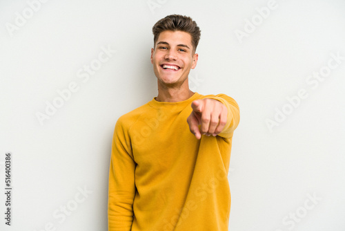 Young caucasian man isolated on white background cheerful smiles pointing to front.