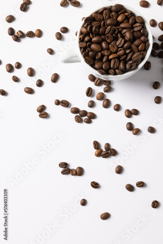 Image of pill of a coffee beans and cup of coffee beans on white background