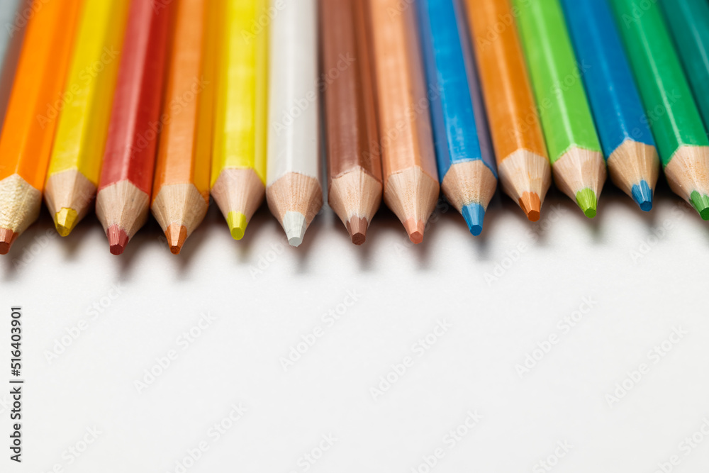 Composition of colorful crayons on white surface with copy space Composition of colorful crayons on white surface with copy space