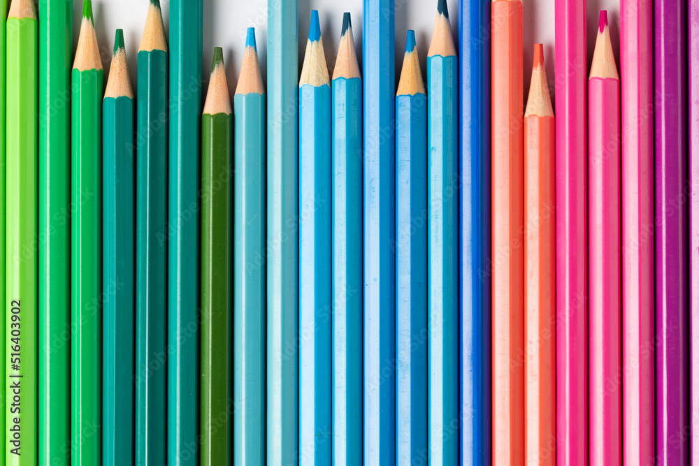 Composition of colorful crayons on white surface Composition of colorful crayons on white surface