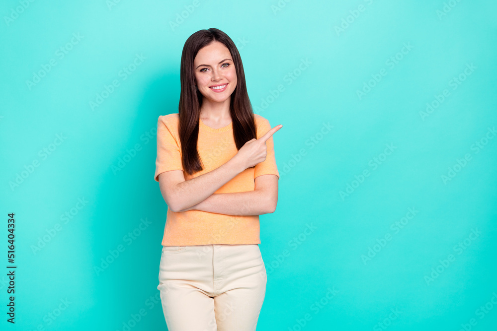 Portrait of gorgeous glad girl direct finger empty space feedback tips isolated on teal color background Portrait of gorgeous glad girl direct finger empty space feedback tips isolated on teal color background