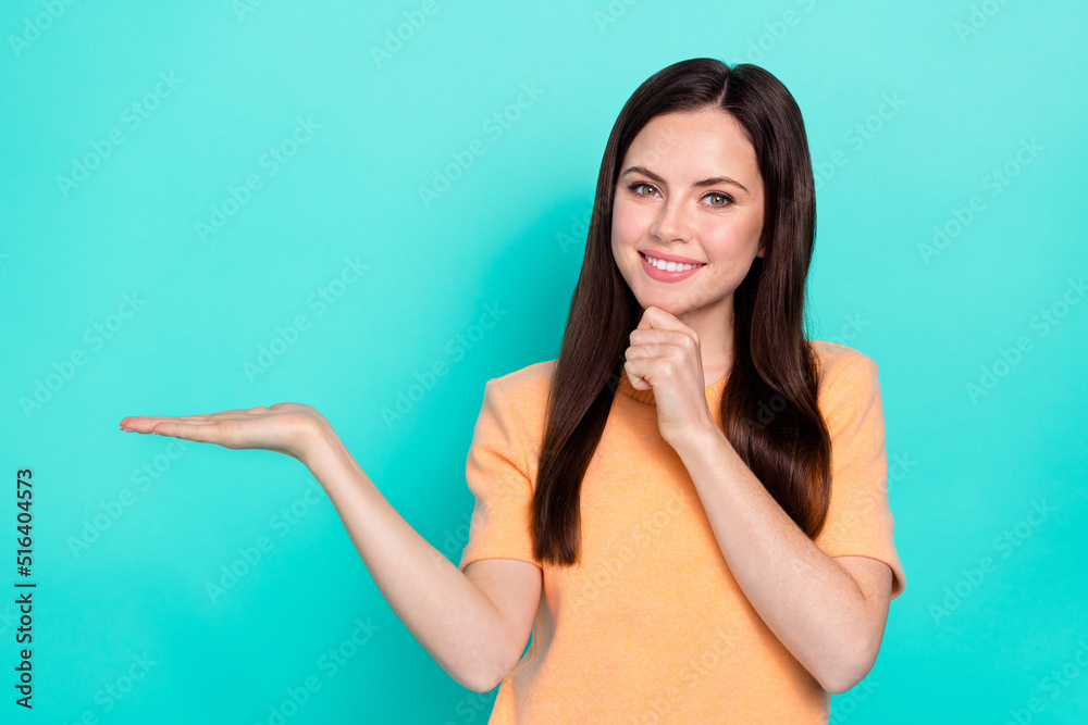 Photo of cheerful nice girl touch chin arm hold empty space proposition isolated on turquoise color background Photo of cheerful nice girl touch chin arm hold empty space proposition isolated on turquoise color background