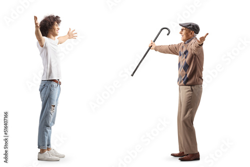 Full length profile shot of a casual guy with curly hair meeting an elderly man