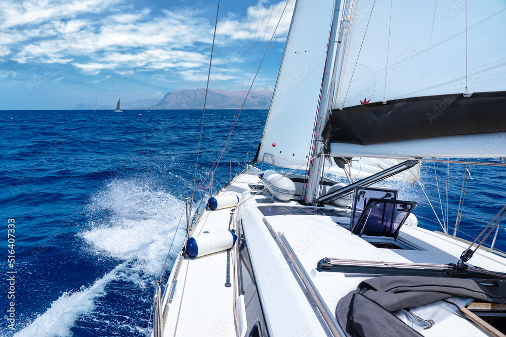 Obraz premium Summer yacht cruise on the Mediterranean Sea around the coast of Sicily on a hot summer day