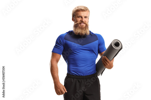 Man with beard and moustache holding an exercise mat